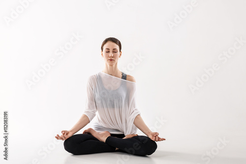 Woman practicing yoga in the lotus position