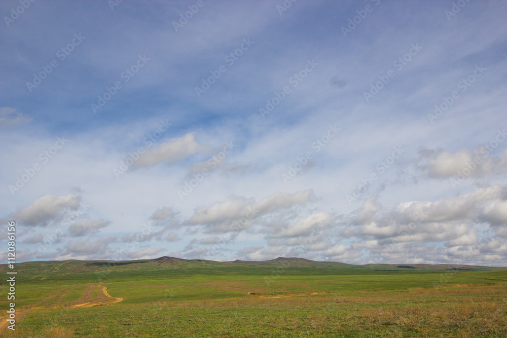 Spring in the steppe and blues sky with clouds - near Almaty Kaz Spring in the steppe and blues sky with clouds - near Almaty Kaz