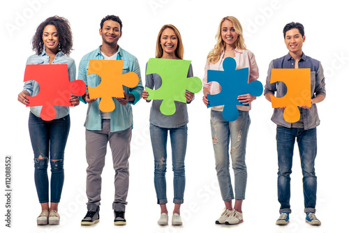 Fototapeta Young people with puzzles