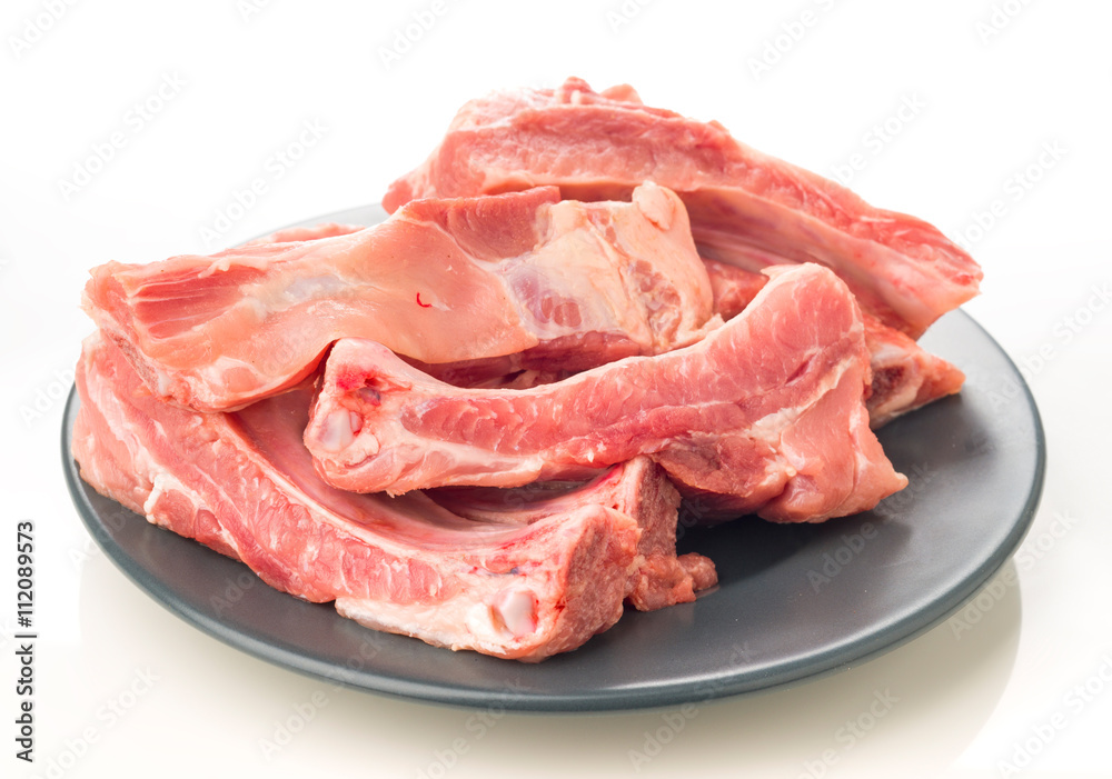 plate of raw pork ribs on white plate of raw pork ribs on white