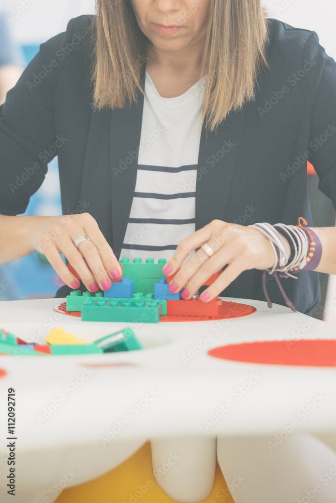 Fototapeta premium Close-up of adult woman playing with blocks