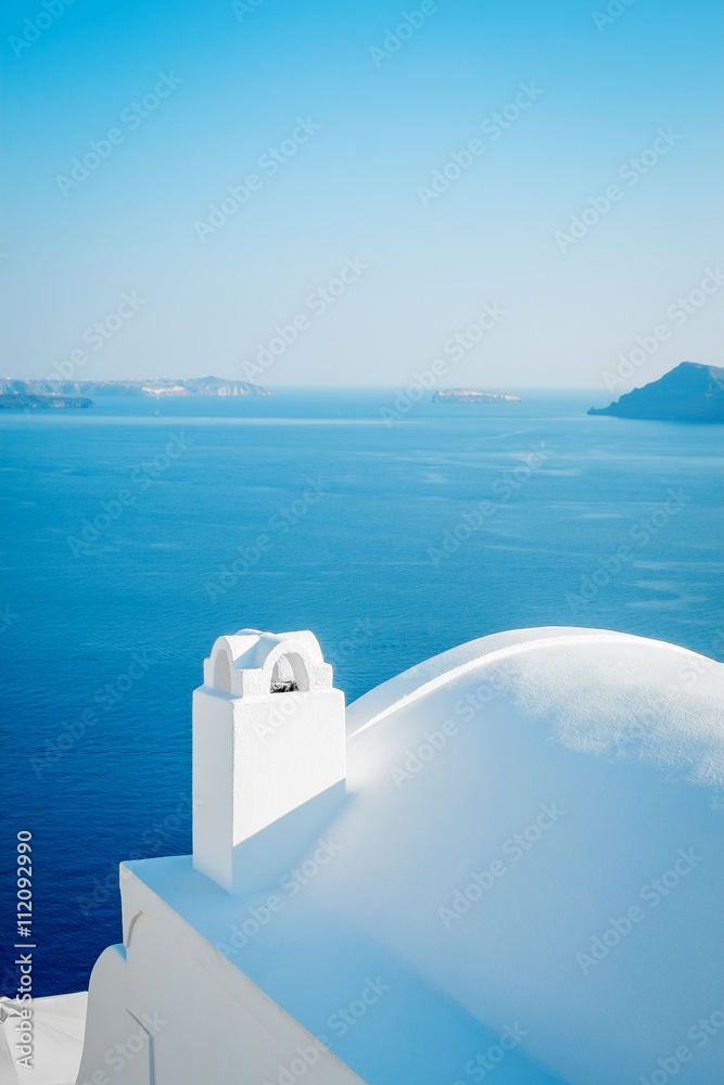 White building against blue sky and sea in Santorini island, Oia, Greece