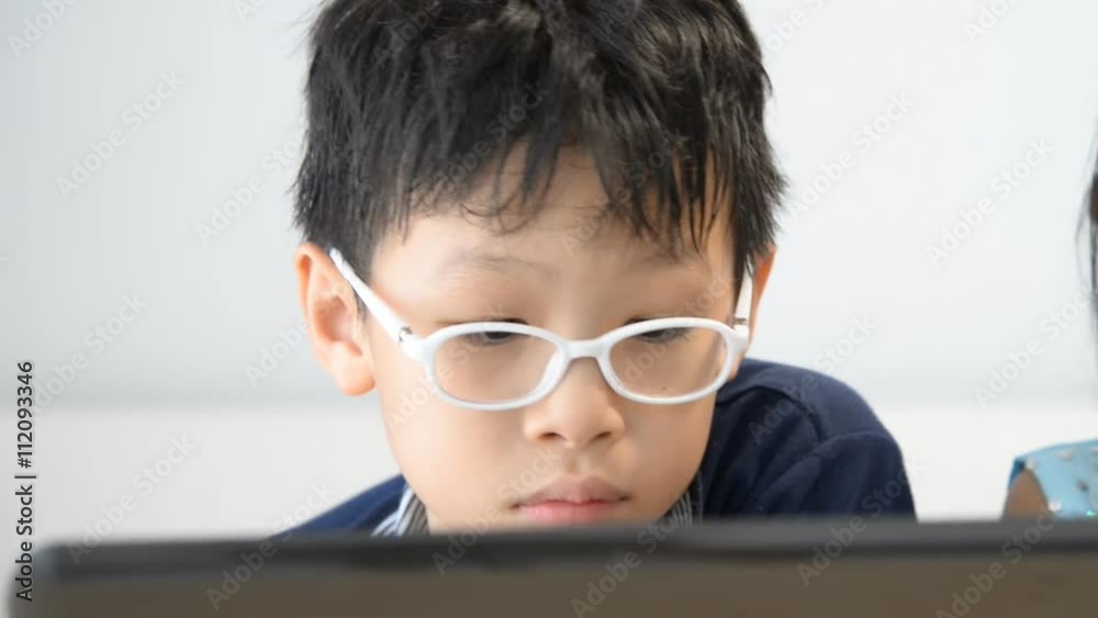 Asian boy using notebook at home Asian boy using notebook at home