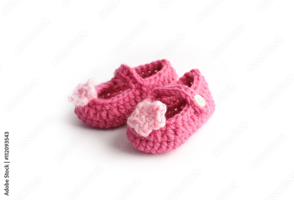 Lovely handmade cute baby red shoes with pink flower made by wool, isolated on white background Lovely handmade cute baby red shoes with pink flower made by wool, isolated on white background