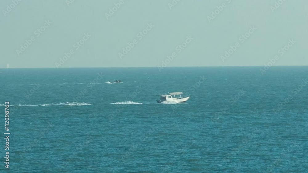 Motor boat moving from harbor to Gulf near the Sharq Marina morning timelapse after sunrise in Kuwait. Kuwait City, Middle East Motor boat moving from harbor to Gulf near the Sharq Marina morning timelapse after sunrise in Kuwait. Kuwait City, Middle East