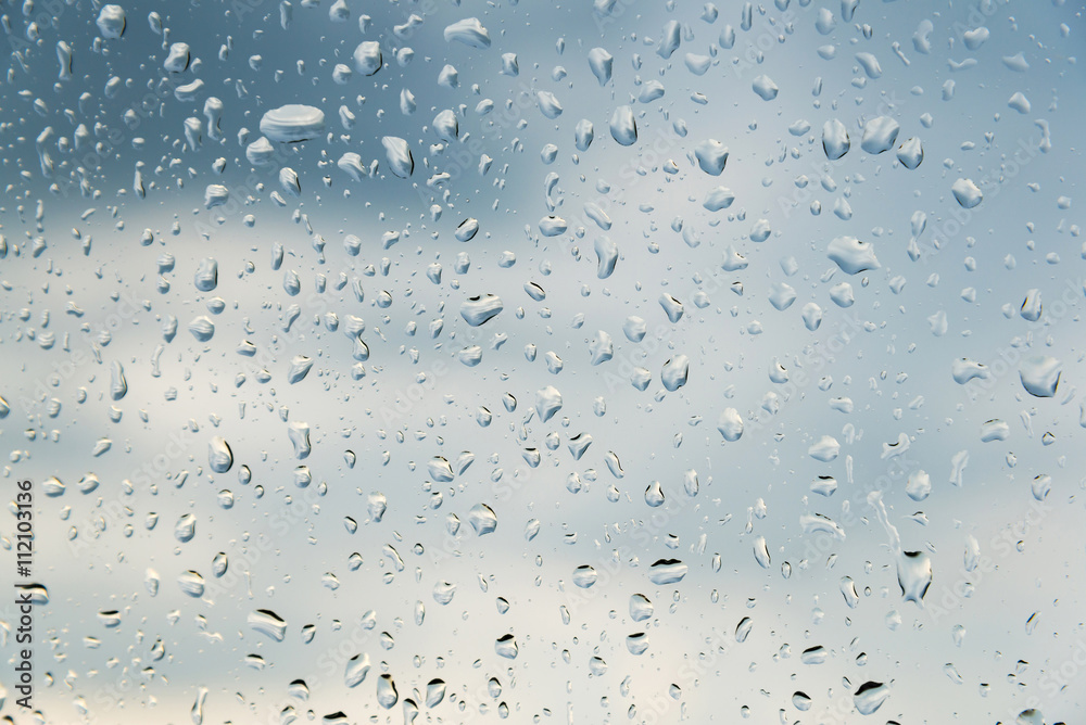 water drops on glass, sky background water drops on glass, sky background