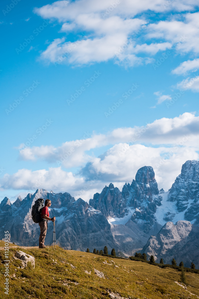 hiker in front of Alps mountains