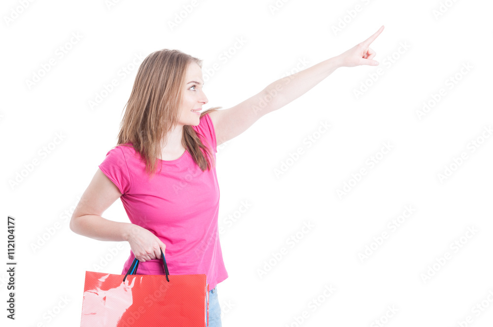 Side portrait of beautiful woman doing shopping and pointing fin