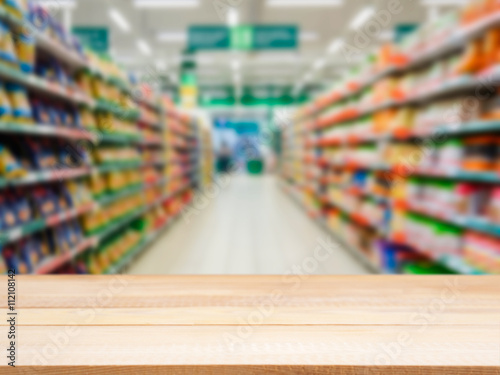 Wooden empty table in front of blurred supermarket