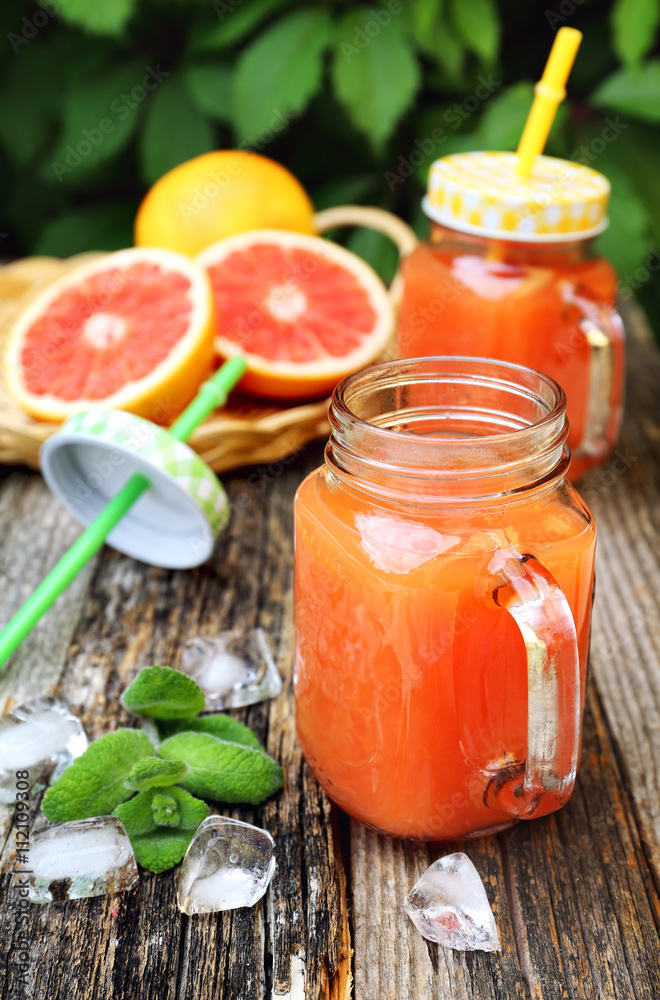 Grapefruit juice in two glass jar, open-air drink Grapefruit juice in two glass jar, open-air drink
