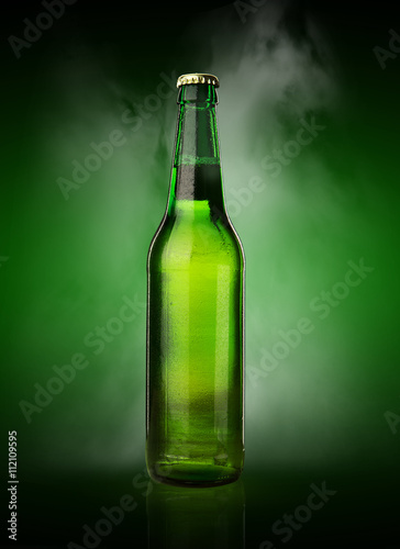 Cold wet beer bottle with frost and vapor