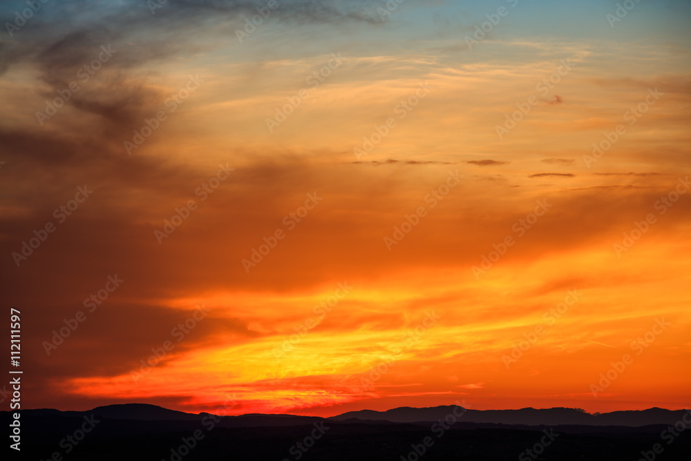 Vibrant sunset above landscape