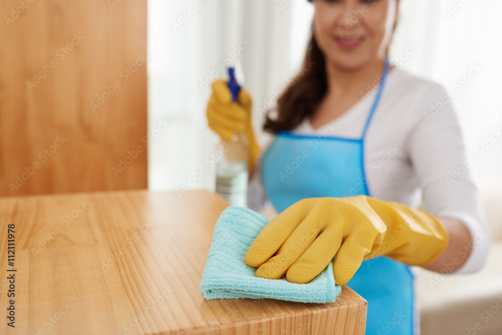 Cropped image of woman cleaning surface with detergent Cropped image of woman cleaning surface with detergent