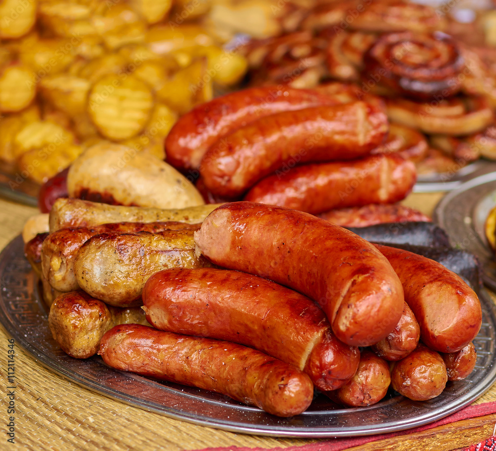 grilled sausages on a plate on a table close-up grilled sausages on a plate on a table close-up
