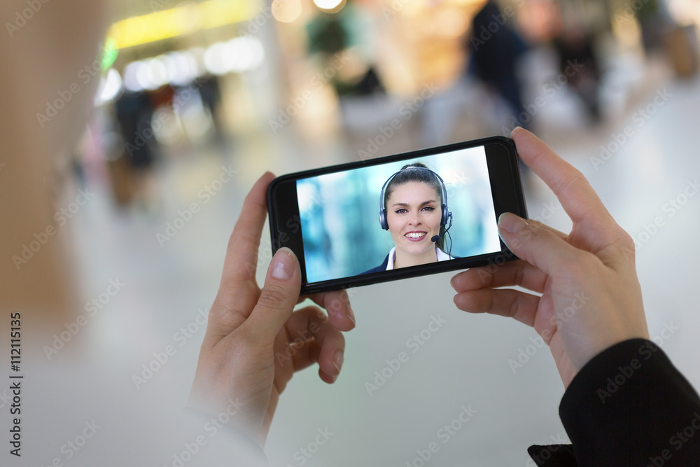 woman hand holding a smartphone during a skype session