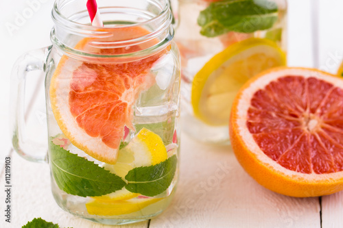 Homemade healthy smoothie with grapefruit and lemon in jar.