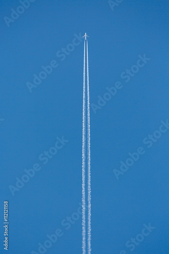 Aircraft in air with sky trails