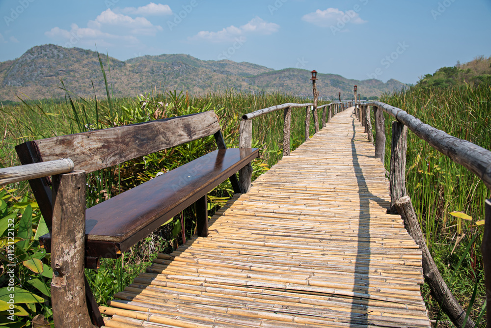 bamboo bridge walkway through the green forest