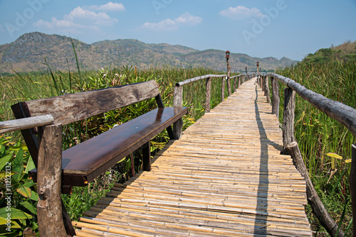 bamboo bridge walkway through the green forest