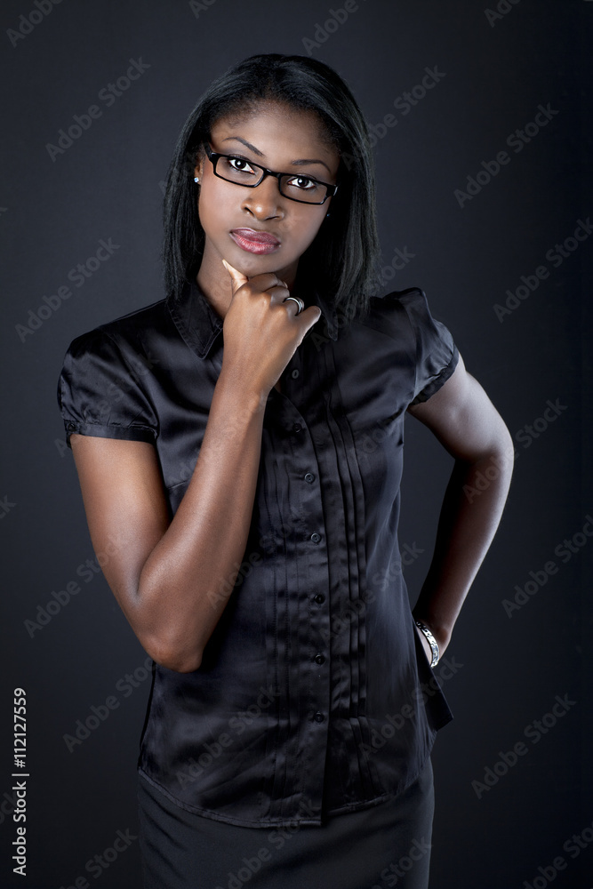confident young businesswoman with hand on chin.