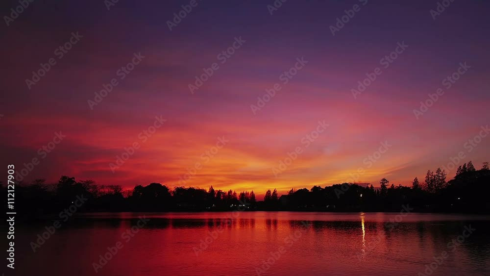 Red twilight sky with reflection on water Red twilight sky with reflection on water