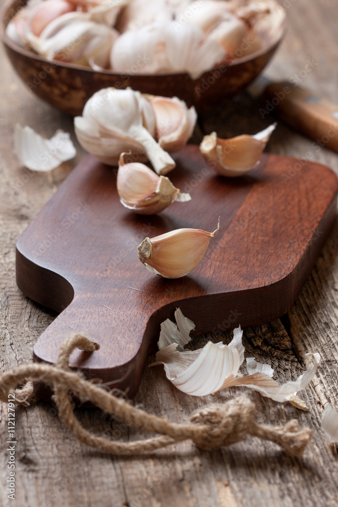 cloves of garlic on a cutting board