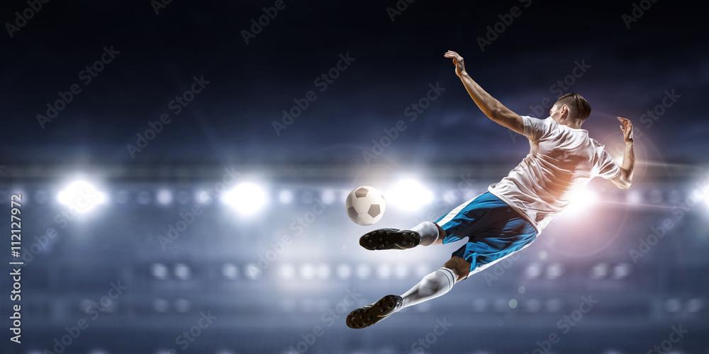 Soccer player hitting ball