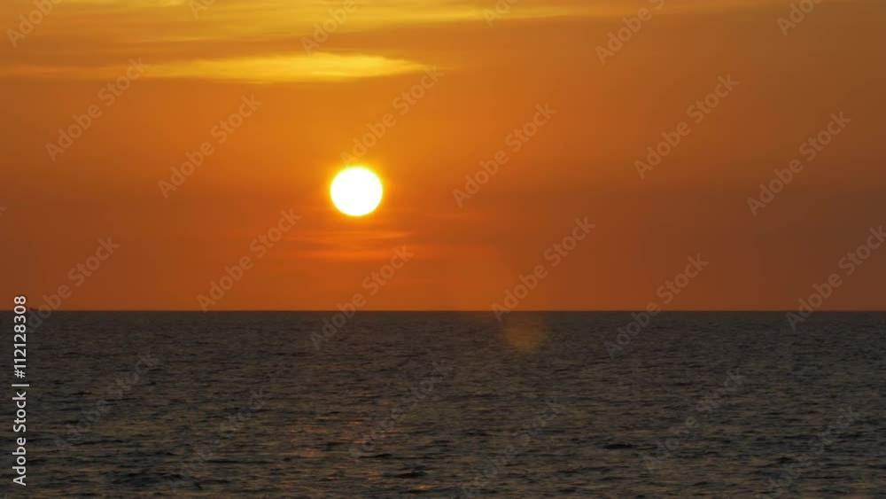 A beautiful yellow/orange sunset with a fiery sky over the ocean in Mai Khao, northern Phuket in Thailand. Filmed in 4k UHD resolution from the Mai Khao paradise beach. A beautiful yellow/orange sunset with a fiery sky over the ocean in Mai Khao, northern Phuket in Thailand. Filmed in 4k UHD resolution from the Mai Khao paradise beach.