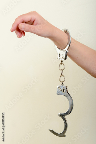 Hands of a woman with handcuffs