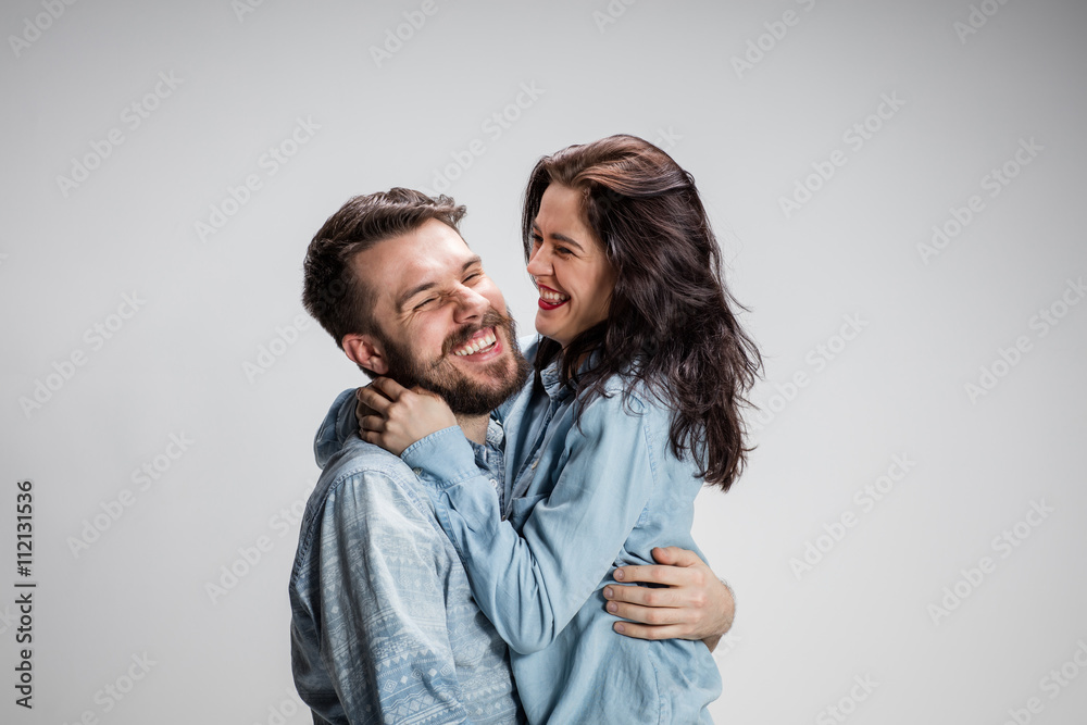 Portrait of happy couple on gray background Portrait of happy couple on gray background