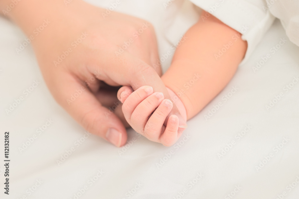 selective focus hand the sleeping baby in the hand of mother clo selective focus hand the sleeping baby in the hand of mother clo
