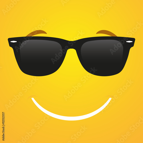 Smile emoticon in sunglasses on a yellow background