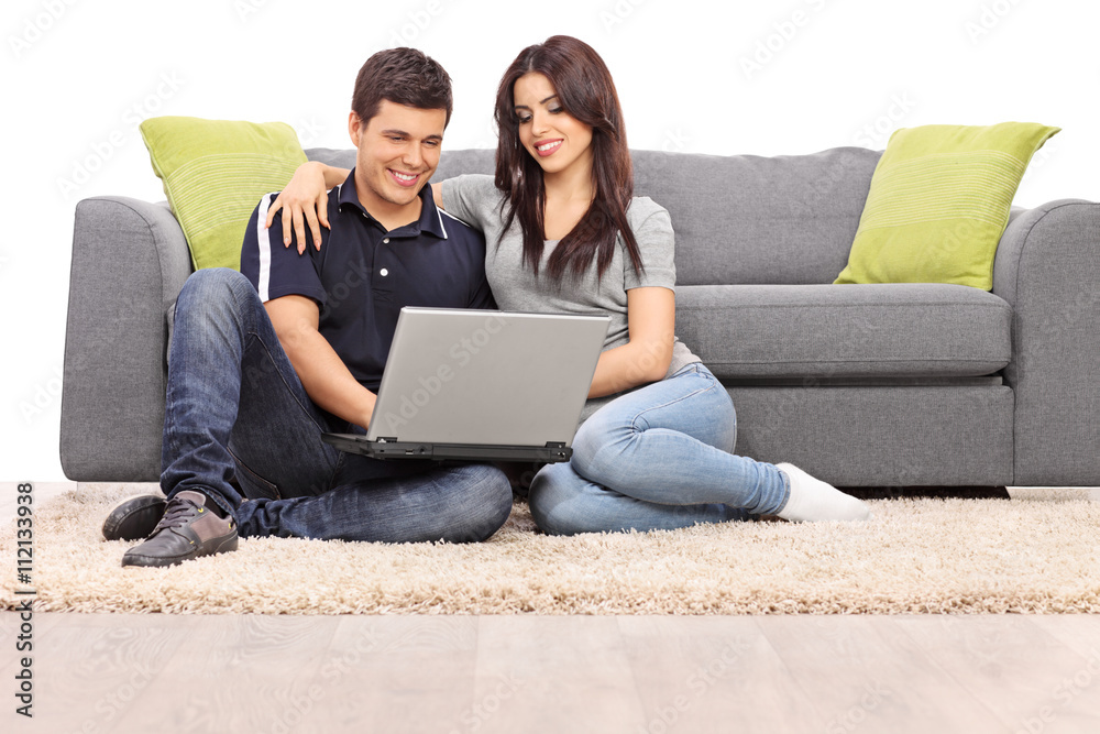Young couple playing on a laptop