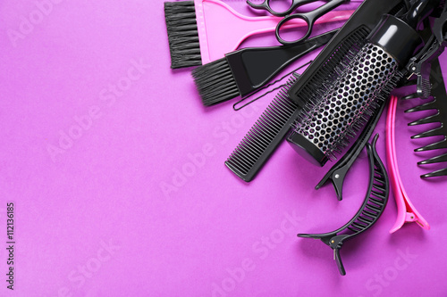 Hairdresser set with various accessories on violet background