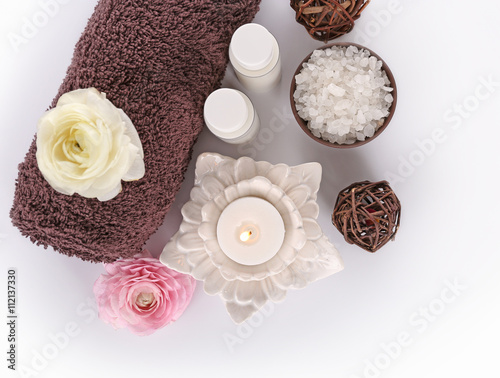 Spa treatment with towel and candle  isolated on white