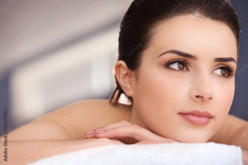 Young woman relaxing in spa center