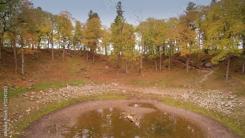 The watery metoerite crater in Kaali. This crater is being surrounded with trees that is found in the middle of the forest