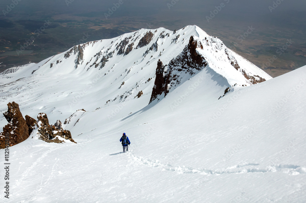 Male climber descends from the top of Erciyes volcano.