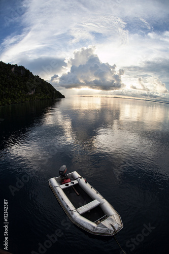 Small Boat at Sunset in Tropical Pacific