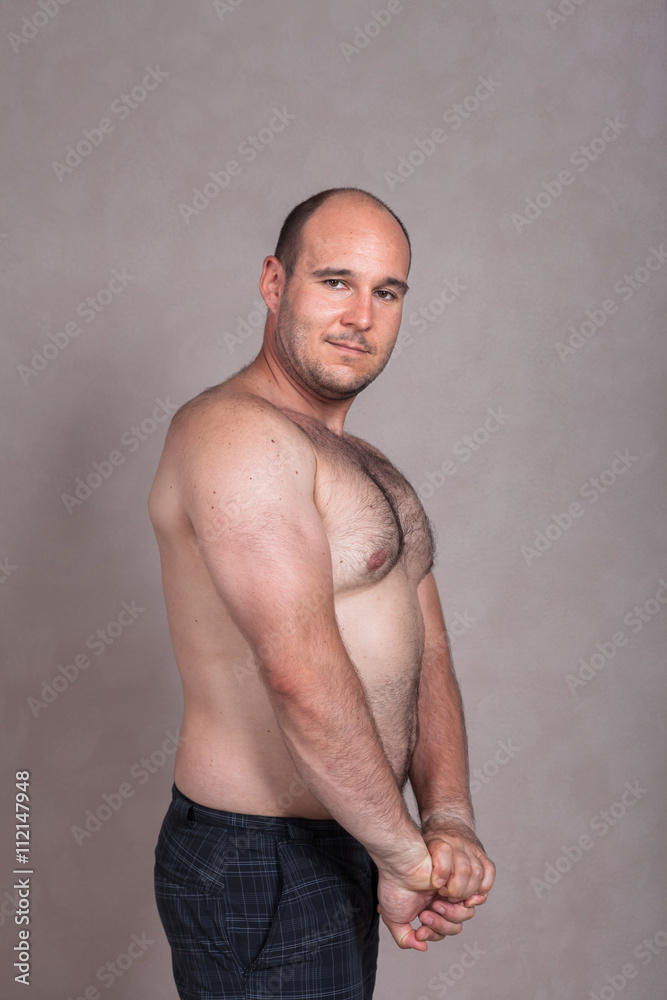 Fototapeta premium Shirtless man showing his triceps and strong body