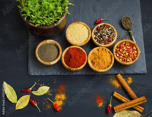 Spices powders and seeds with chili peppers and bay leaves