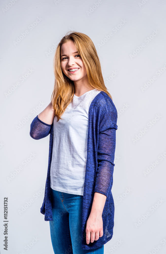 Girl in jeans and long sweater, woman, studio shot Girl in jeans and long sweater, woman, studio shot
