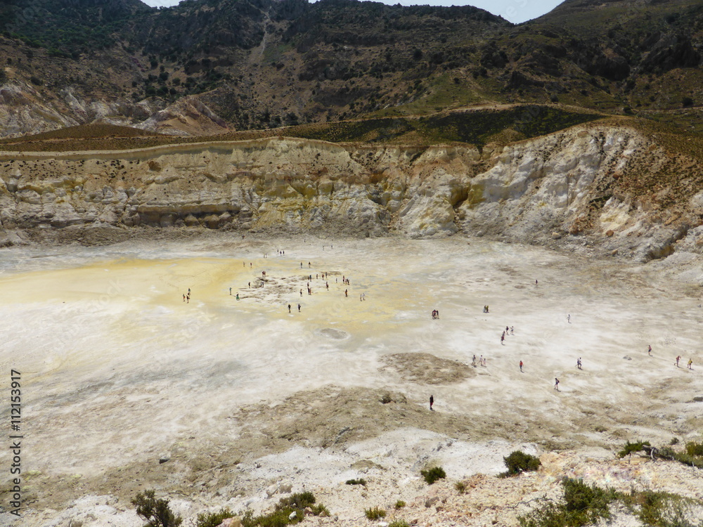 Stefanos crater. The volcano on the island of Nisyros. Greece. Tourists walking inside the crater.
