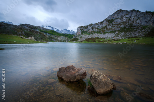 Lake Enol with snow-capped mountains in the background, in the natural park of the Picos de Europa, Covadonga, Asturias, Spain