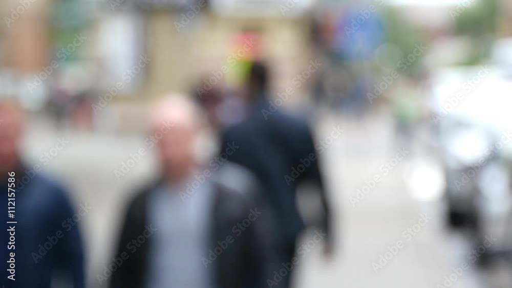 Crowds of people walking in street