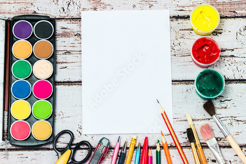 A set of stationery on wooden background, the place of the artist