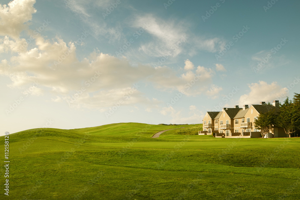 View of nice green valley and cozy house in summer environment