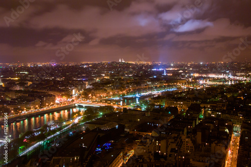 Aerial Night view of Paris City and Seine river shot on the top of Eiffel Tower © jon11