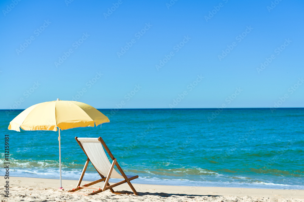 Chair and umbrella on stunning tropical beach background vacation 