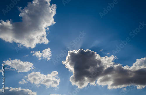 Blue sky with sun and clouds